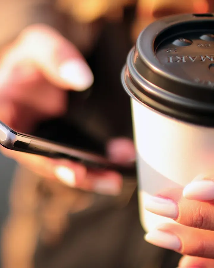 Reading the news on a phone over coffee
